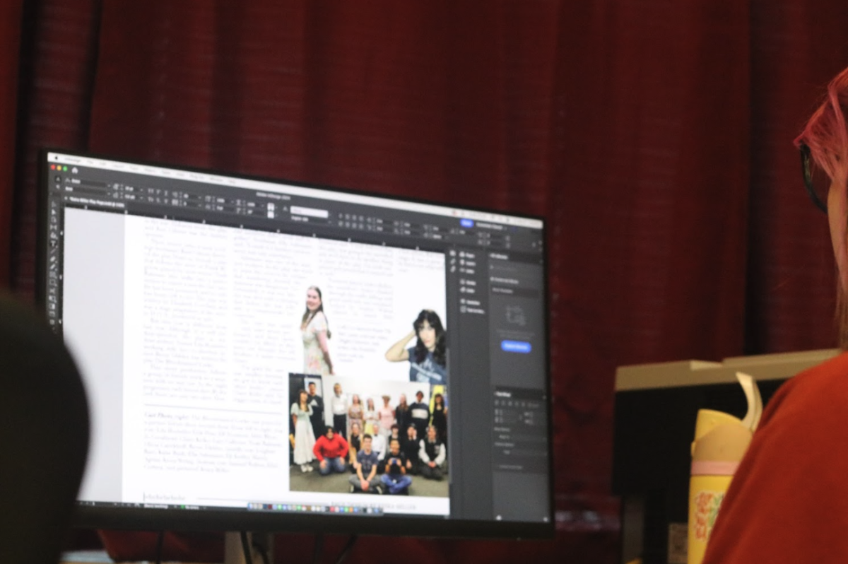 Newspaper student works on a page for the newspaper.